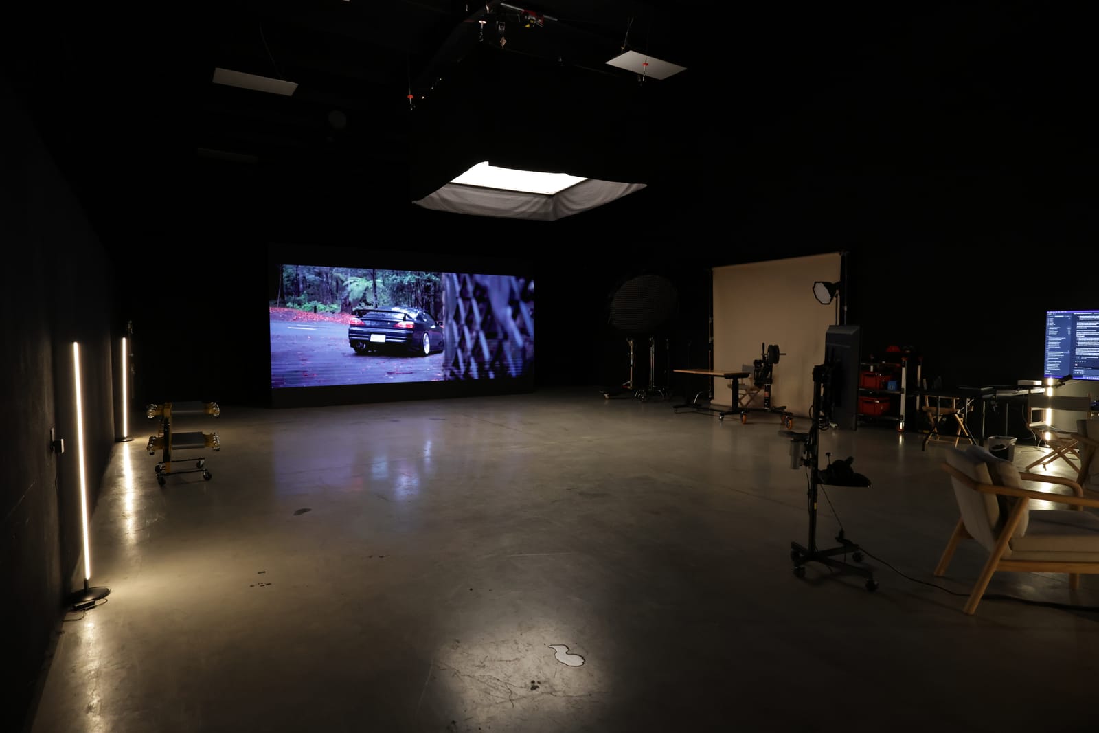 The Asper Studios stage in Dallas Fort Worth, LED wall lit, grip and lighting gear staged across the floor